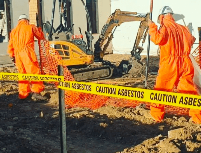 asbestos removal workers on site removing asbestos materials.